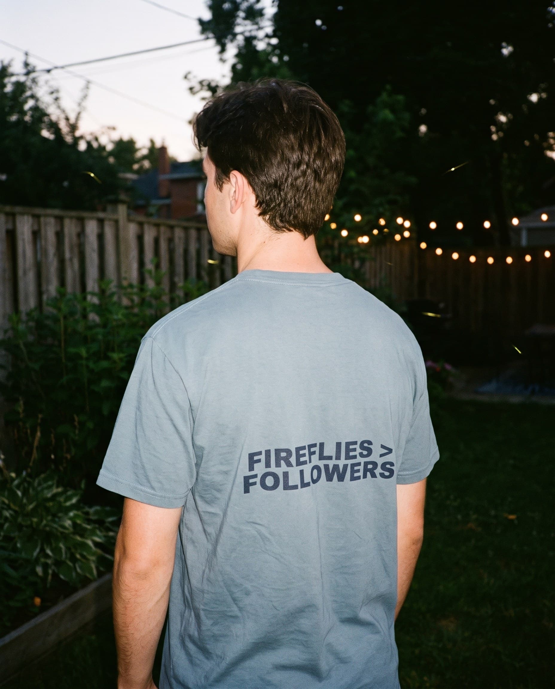 Back view of the "FIREFLIES > FOLLOWERS" tee