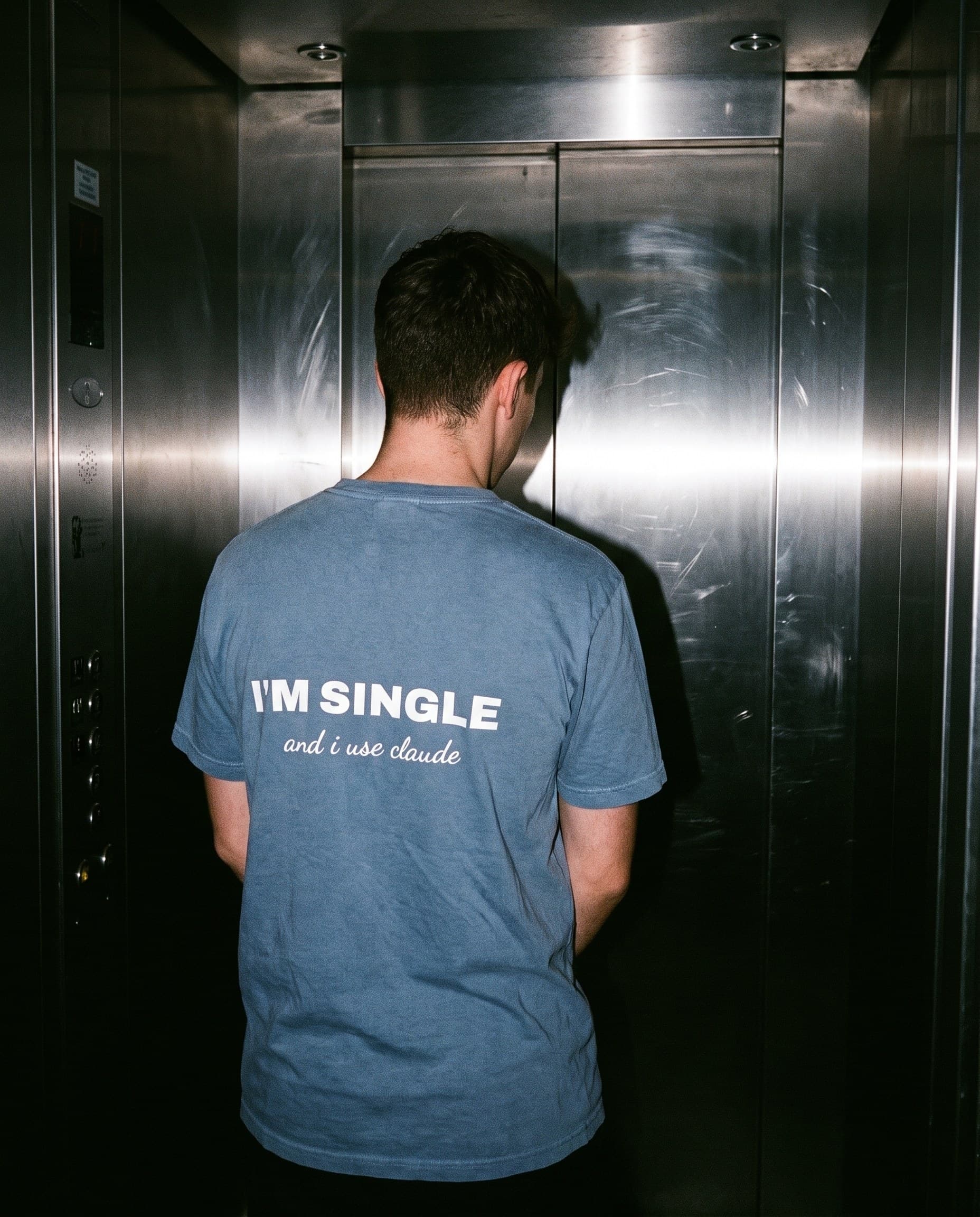 Back view of the "I'M SINGLE & I USE CLAUDE" tee