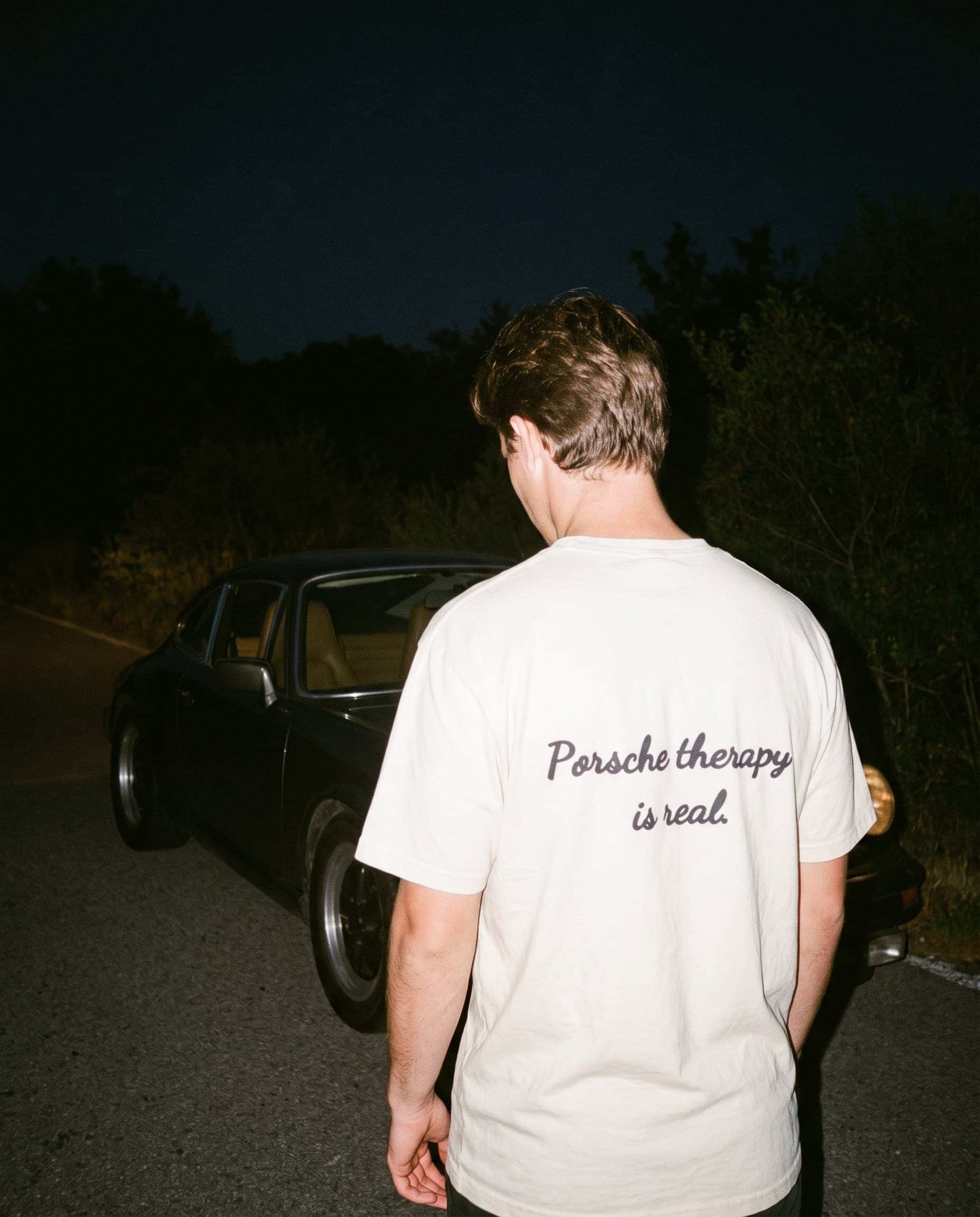 Back view of the "Porsche therapy is real." tee