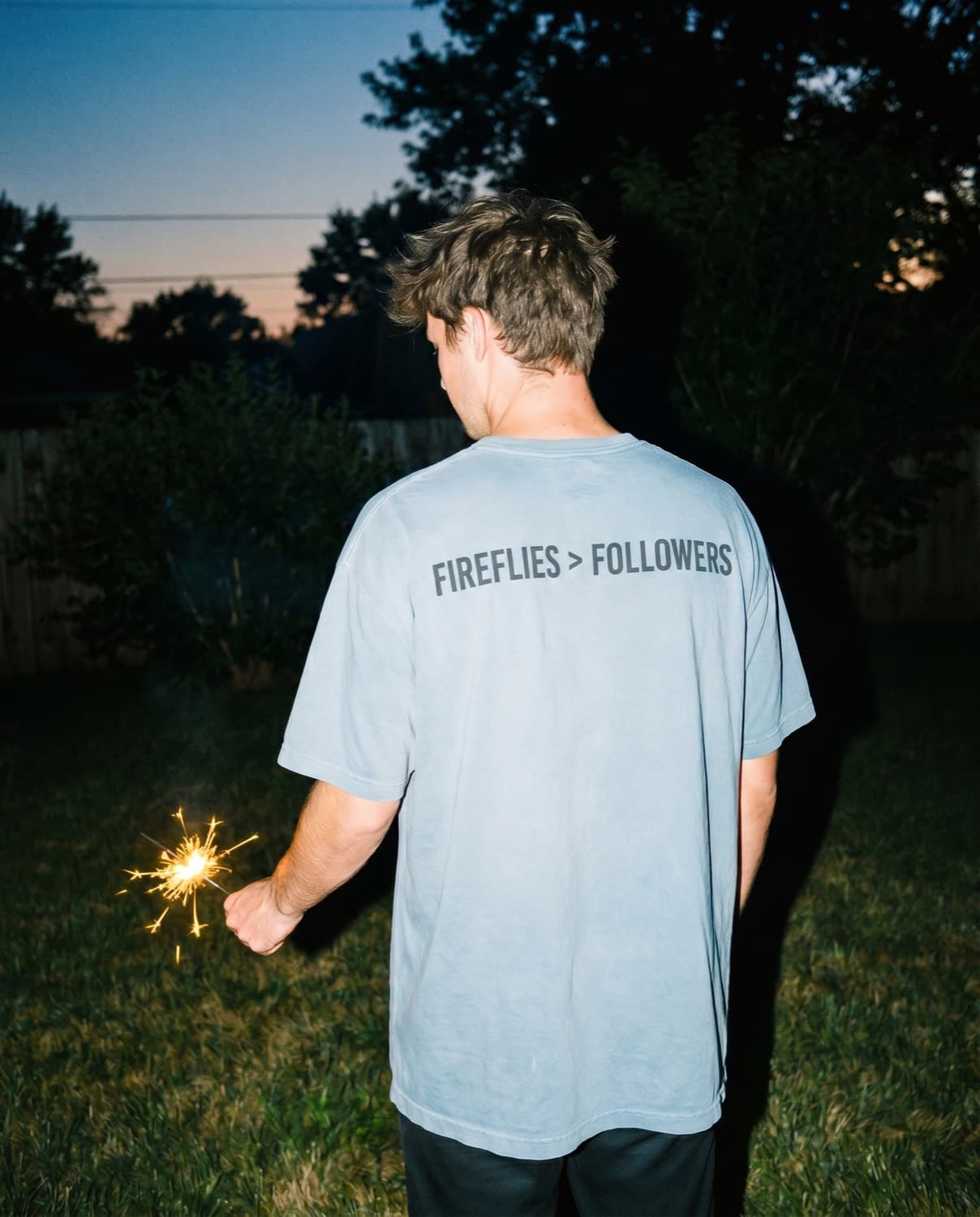 Back view of the "FIREFLIES > FOLLOWERS" tee